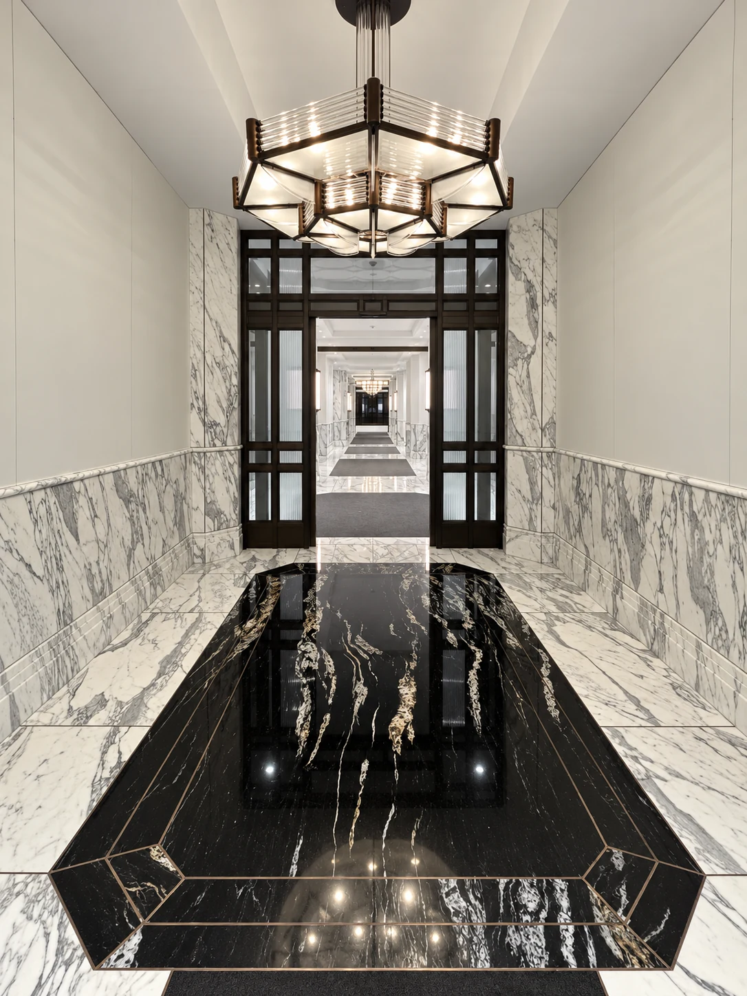 Natural stone slab floor and wall finishes framing an interior corridor