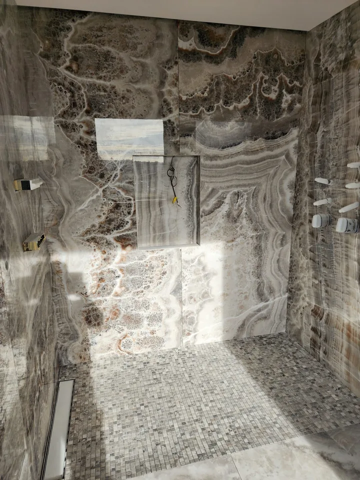 Shower interior showing wall-panel joints and a floor drain