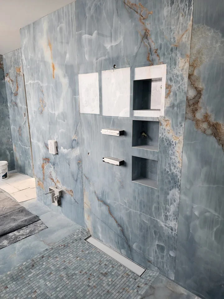 Blue wall panels surrounding a recessed shelf during installation