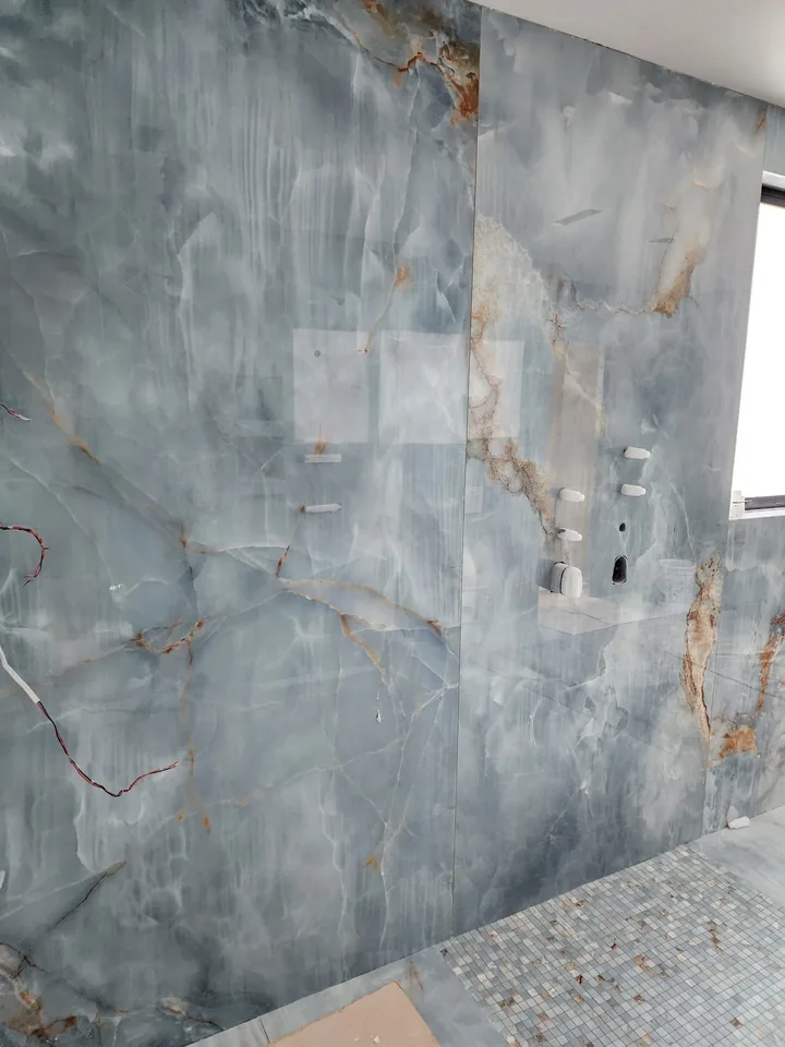 Close view of blue wall panels and unfinished fitting openings