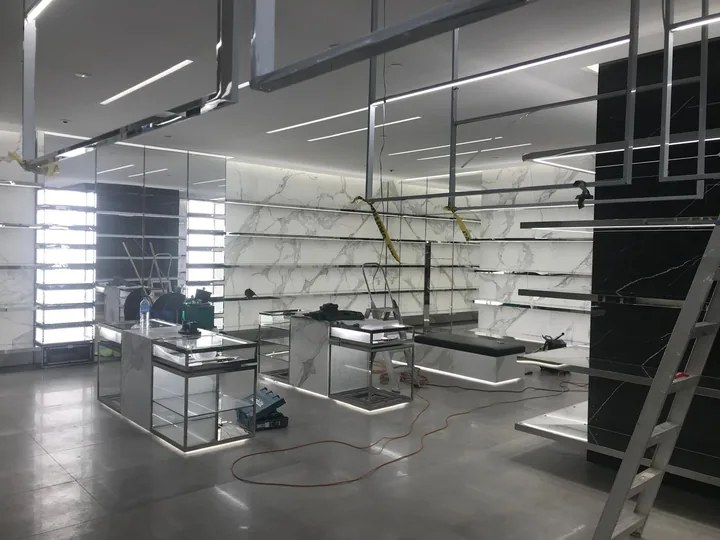 Interior floor and wall finishes around illuminated display fixtures