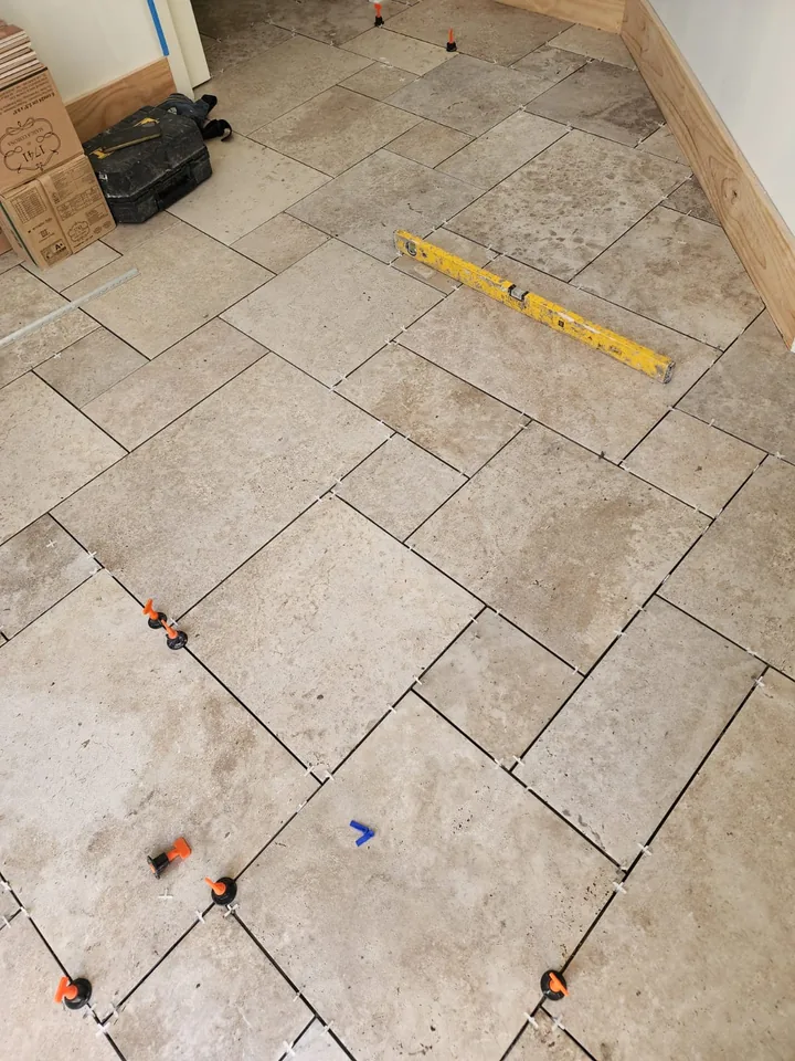 Rectangular floor tiles with fitting spacers beside a doorway
