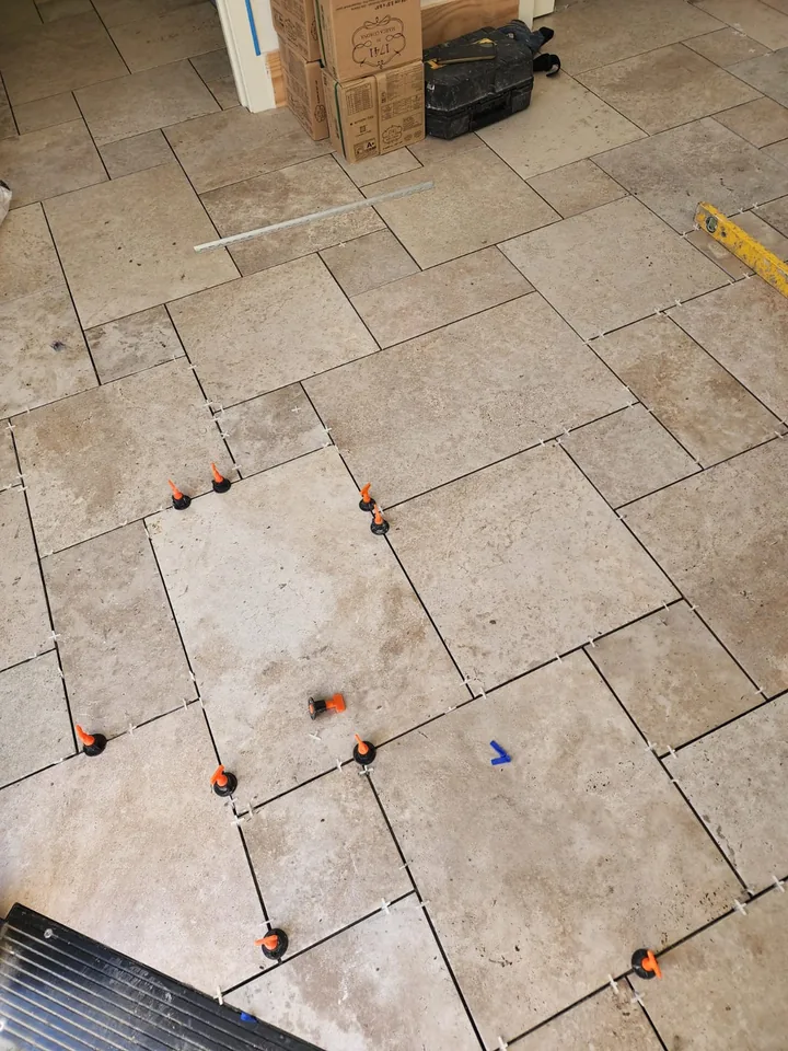 Floor tile installation showing joints and levelling clips